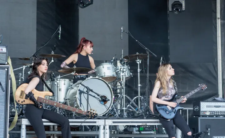 The Warning on stage at the Sound of Music Festival in Burlington, Ontario, in 2022, with bass, drums and guitar