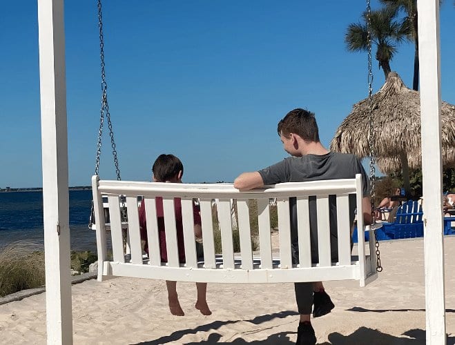 Sitting on a beach swing with a kid
