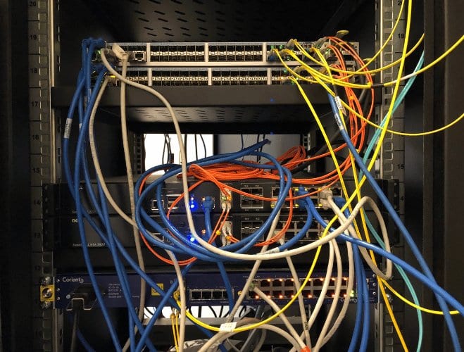 A tangled server rack full of network cables